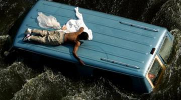 Hurricane Katrina man on car